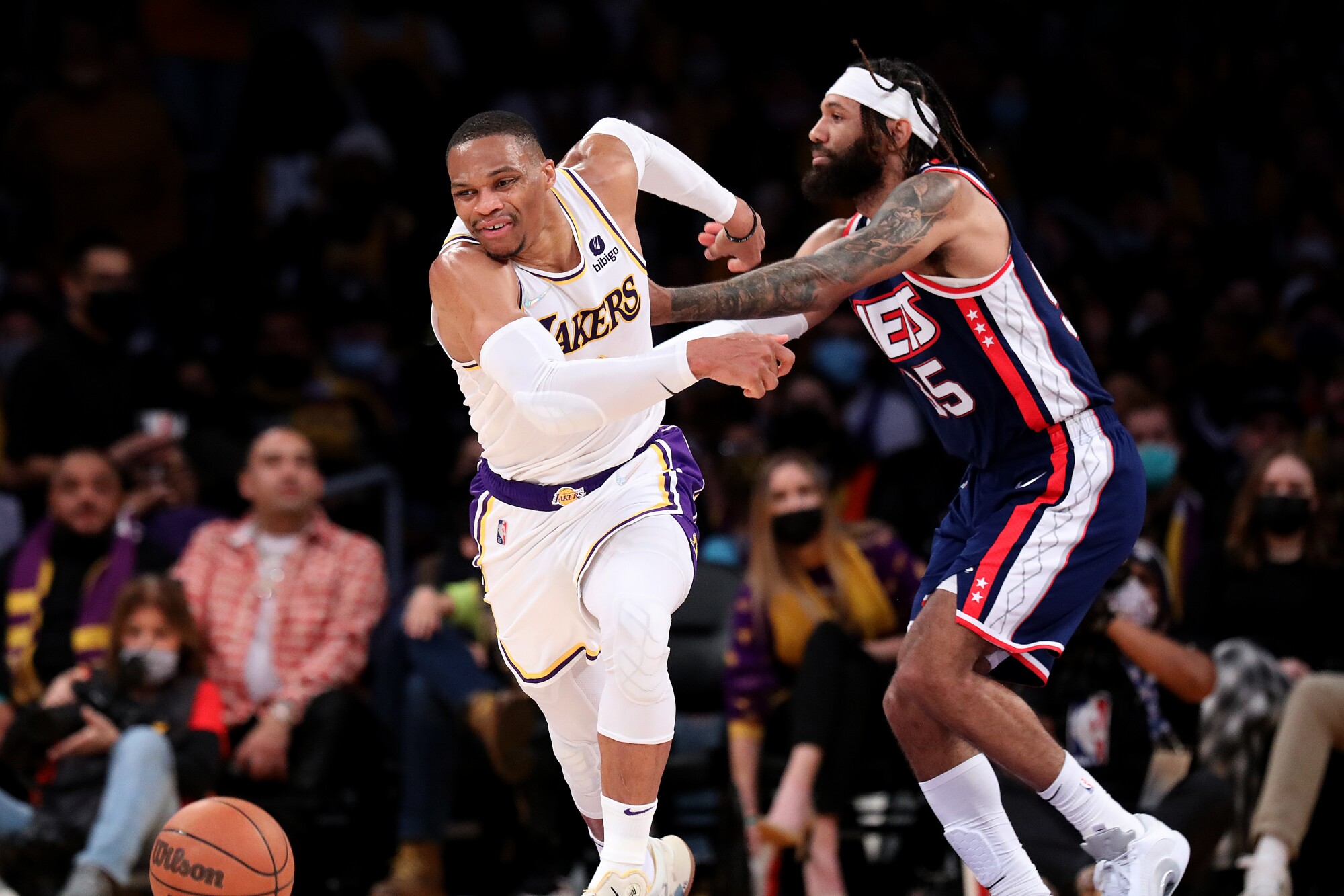 Lakers guard Russell Westbrook, left, is fouled by Brooklyn Nets guard DeAndre' Bembry.