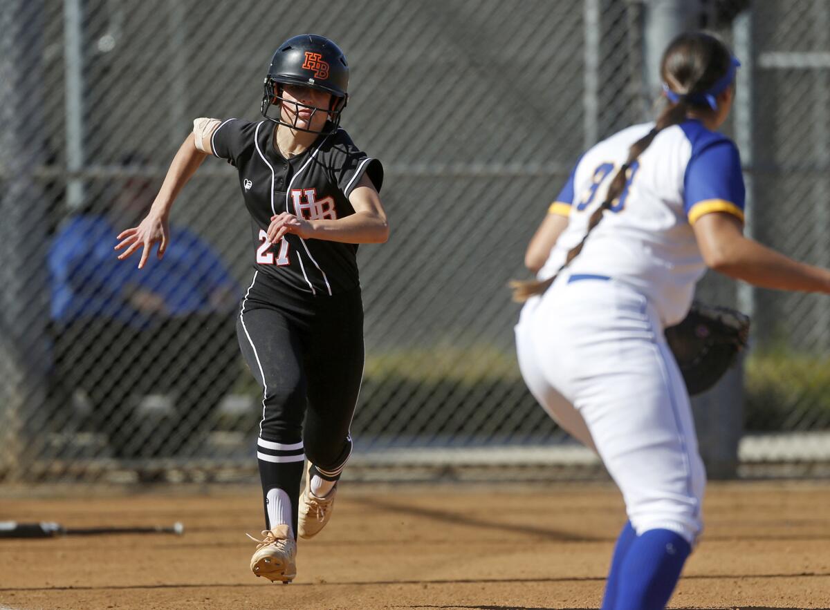 Macy Fuller (27) of Huntington Beach runs to first base against Fountain Valley on Tuesday.