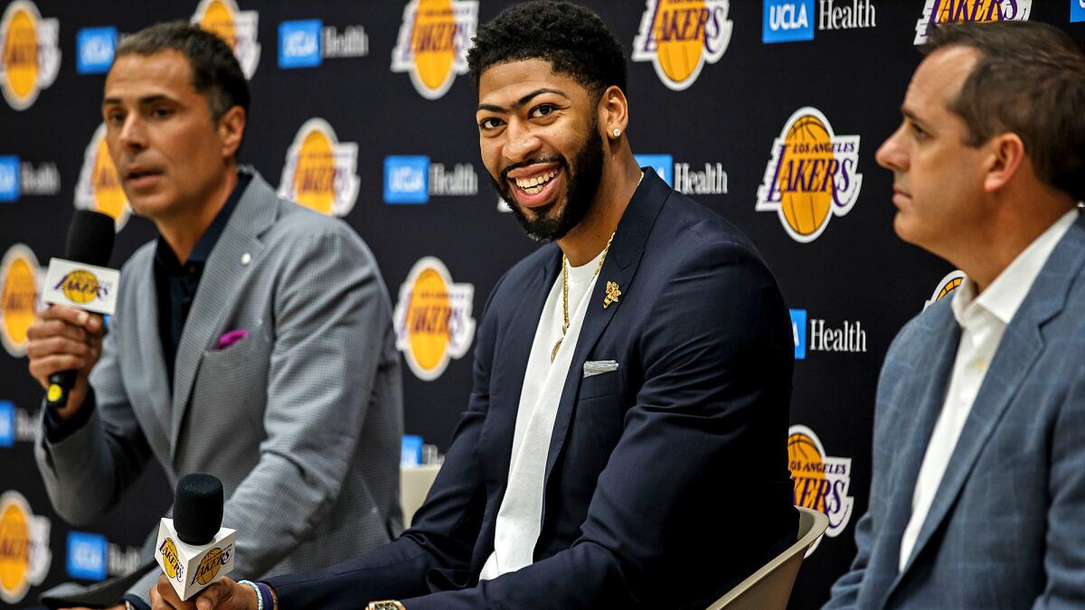 Lakers GM Rob Pelinka, left, addresses the media as he introduces Anthony Davis, who is flanked by head coach Frank Vogel,