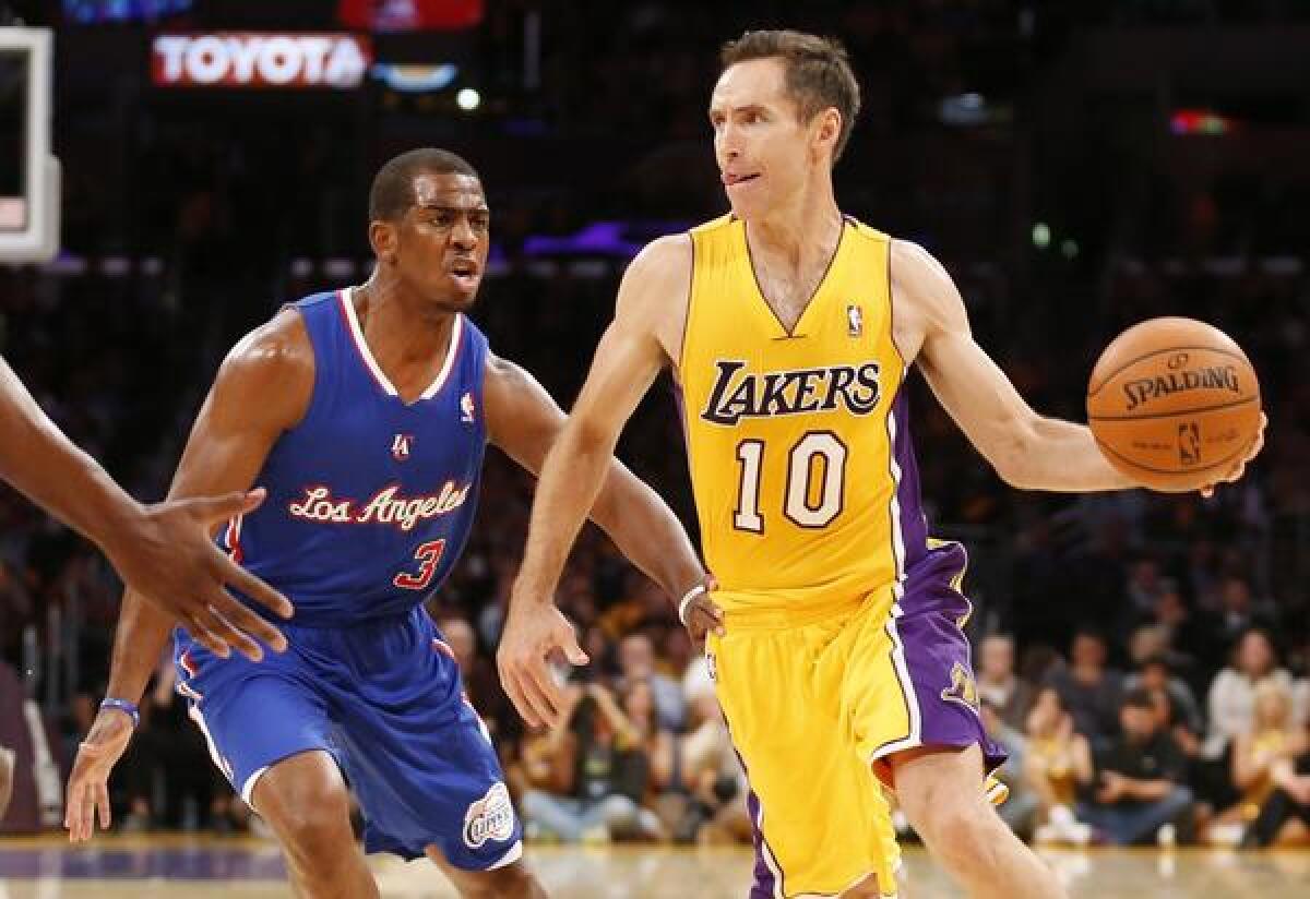 Lakers point guard Steve Nash makes a pass in front of Clippers guard Chris Paul during last month's season opener. Back pain forced Nash to miss the second half of Sunday's loss to the Minnesota Timberwolves.