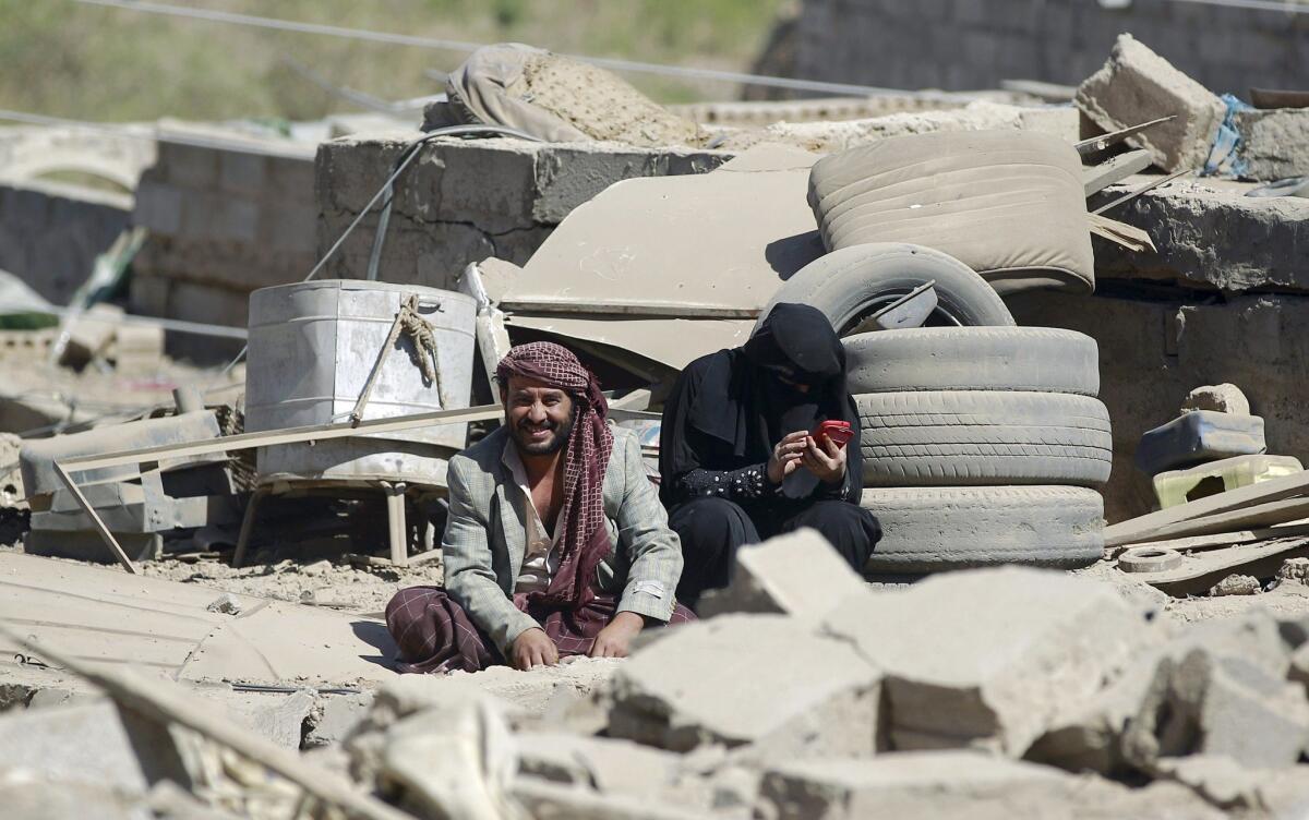 Yemenis sit in the rubble of houses destroyed by an overnight Saudi-led airstrike on a residential area in their capital, Sana, on May 1.