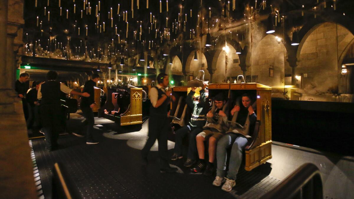 Candlesticks float and hover above the riders aboard Harry Potter and the Forbidden Journey in the Wizarding World of Harry Potter at Universal Studios Hollywood.