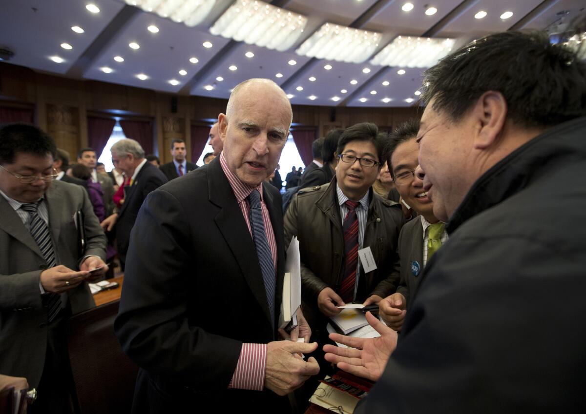 California Gov. Jerry Brown is surrounded by Chinese delegates after a discussion on energy innovation and reducing carbon emissions in Beijing in 2013.