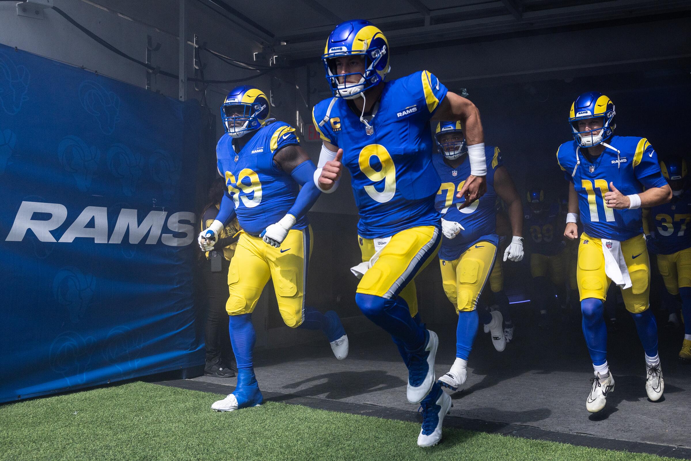 Rams quarterback Matthew Stafford leads his teammates onto the field before a game against the Cardinals at SoFi Stadium.