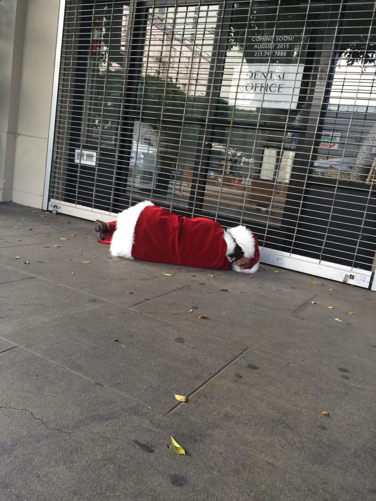 A man dressed as Santa Claus passed out in the middle of the day at 7th and Main. (Dan Johnson)