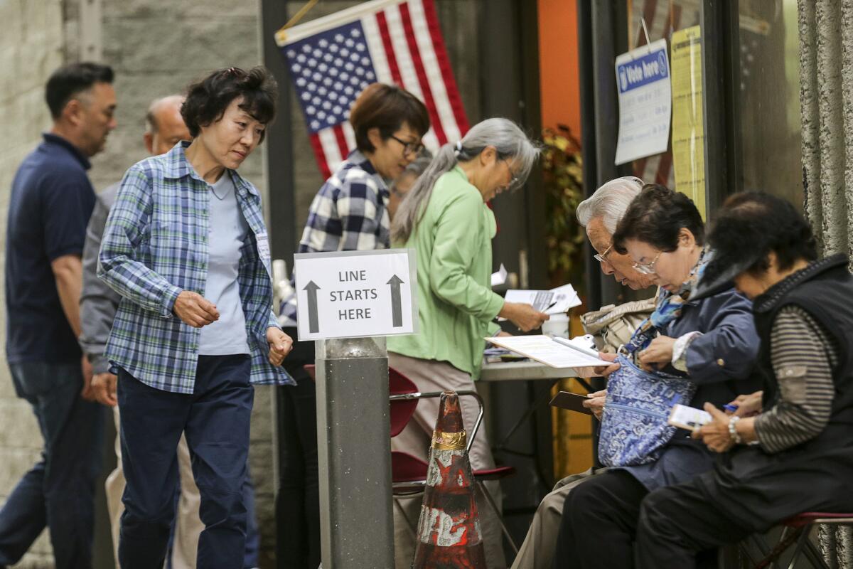 Voters line up at an early voting site at Pio Pico Library in Koreatown on Saturday.