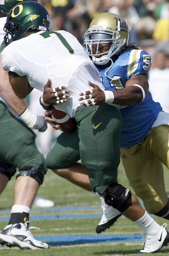 UCLA linebacker Reggie Carter sacks Oregon quarterback Nate Costa in the first quarter Saturday.