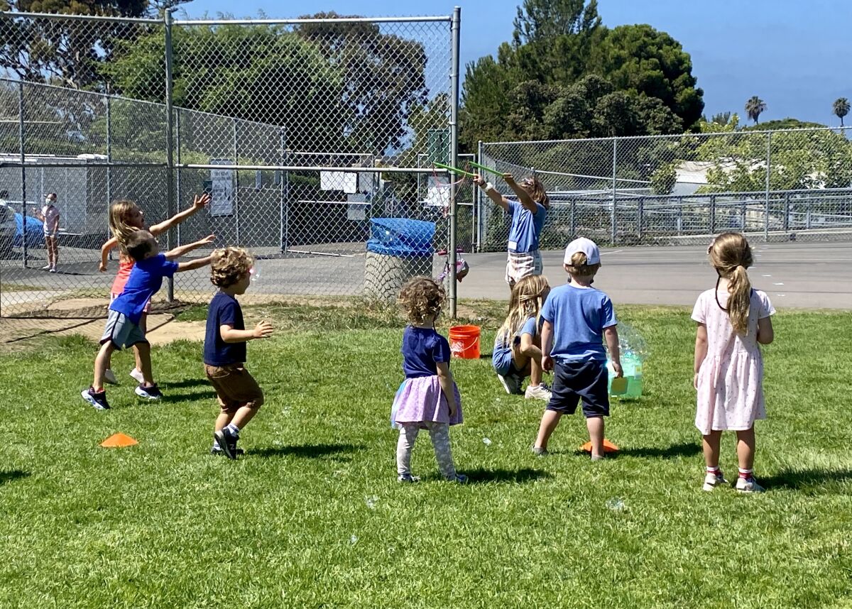 A "Bird Squad" ambassador leads a group of incoming Bird Rock Elementary School kindergarten students in bubble play.