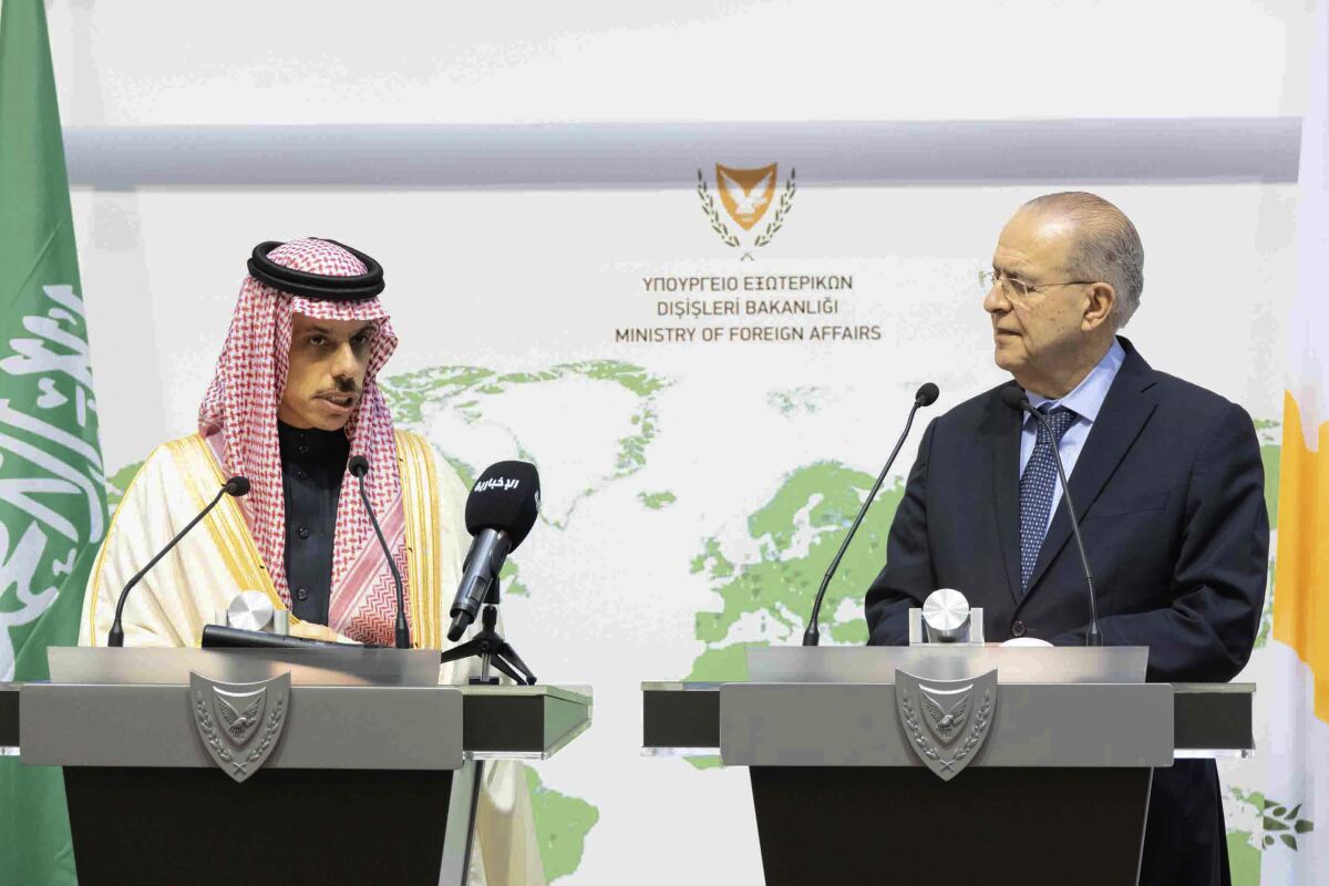 This image provided by Cyprus Press and Informations Office, shows Saudi Foreign Minister Prince Faisal Bin Farhan Al-Saud, left and Cyprus Foreign Minister Ioannis Kasoulides speaking to the media, during a press conference after their meeting, at the foreign ministry house in capital Nicosia, Cyprus, Sunday, Feb. 13, 2022. The Saudi foreign minister says his country views Cyprus as a "bridge" between the Middle East and the European Union, helping the 27-nation bloc "understand what's going on" in the region. (Stavros Ioannides PIO via AP)