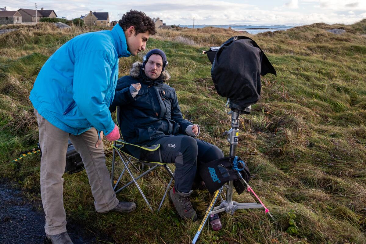 Amir El-Masry and director Ben Sharrock on the set of "Limbo."