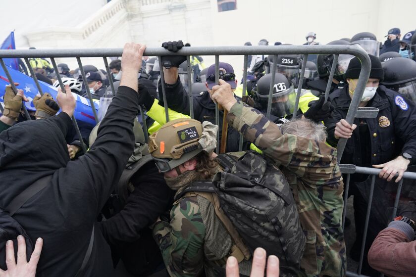WASHINGTON, DC - JANUARY 06: Police try to hold back protesters who gather storm the Capitol and halt a joint session of the 117th Congress on Wednesday, Jan. 6, 2021 in Washington, DC. (Kent Nishimura / Los Angeles Times)