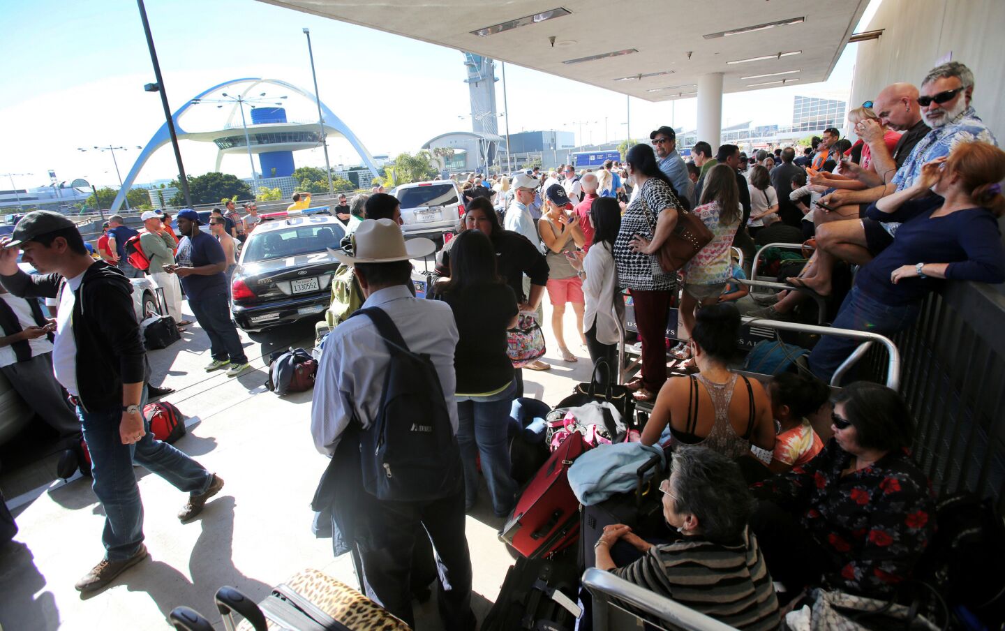 Passengers wait for Terminal 1 to reopen after a shooting at Los Angeles International Airport on Friday.