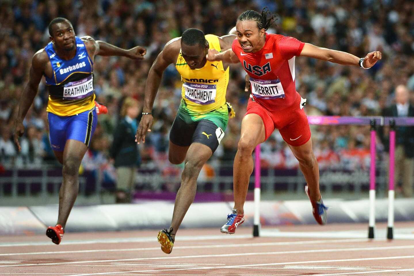 Team USA's Aries Merritt, right, crosses the finish line in front of Barbados' Ryan Brathwaite, left, and Jamaica's Hansle Parchment to win the gold medal in the 110-meter hurdles at the 2012 London Olympics. Jason Richardson of the U.S. won silver.