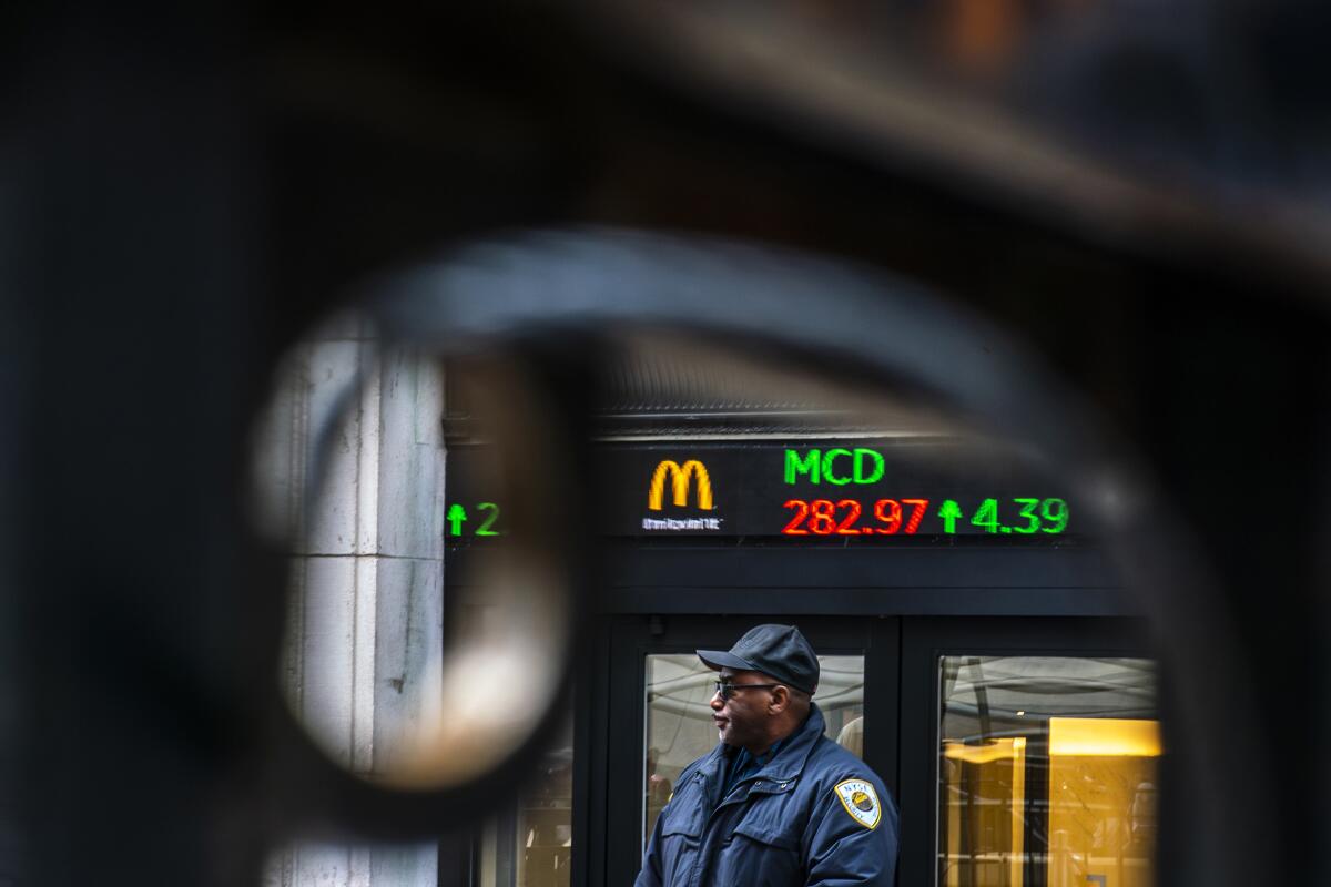 A security guard at an entrance to the New York Stock Exchange
