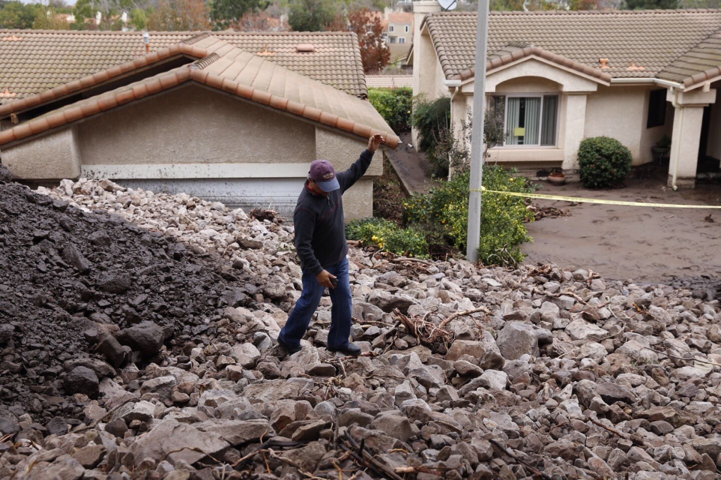 Erwin Fodram, a 20-year resident, looks at homes on Gitana Avenue buried by the debris flow in Camarillo Springs.