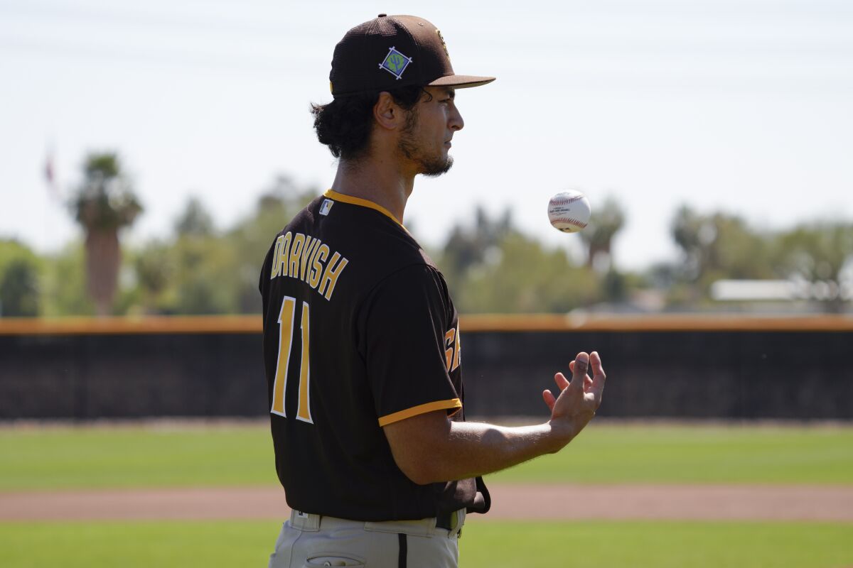 Padres pitcher Yu Darvish tosses a ball during a workout at spring training
