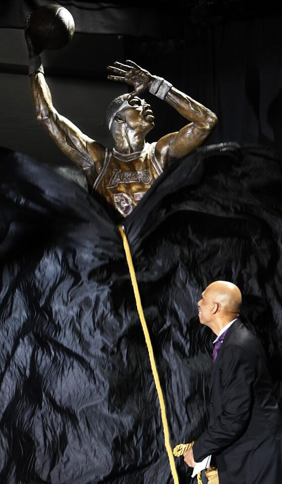 Kareem Abdul-Jabbar unveils a statue of himself during a ceremony on Friday evening outside of Staples Center.