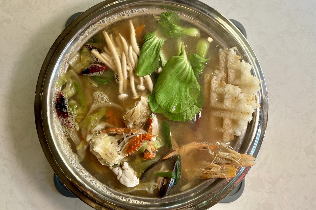 The crispy rice and seafood hot pot at Olle Korean Cuisine is topped with nurungji wafers.