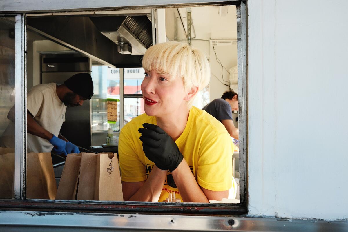Calabama owner Cara Haltiwanger chats with a customer from a window at the new Hollywood restaurant.