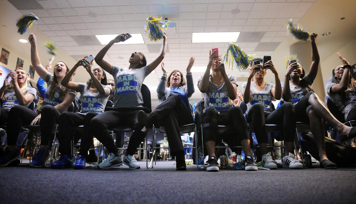 The UCLA womens basketball team reacts to seeing their name appear on TV during the NCAA selection show on campus.