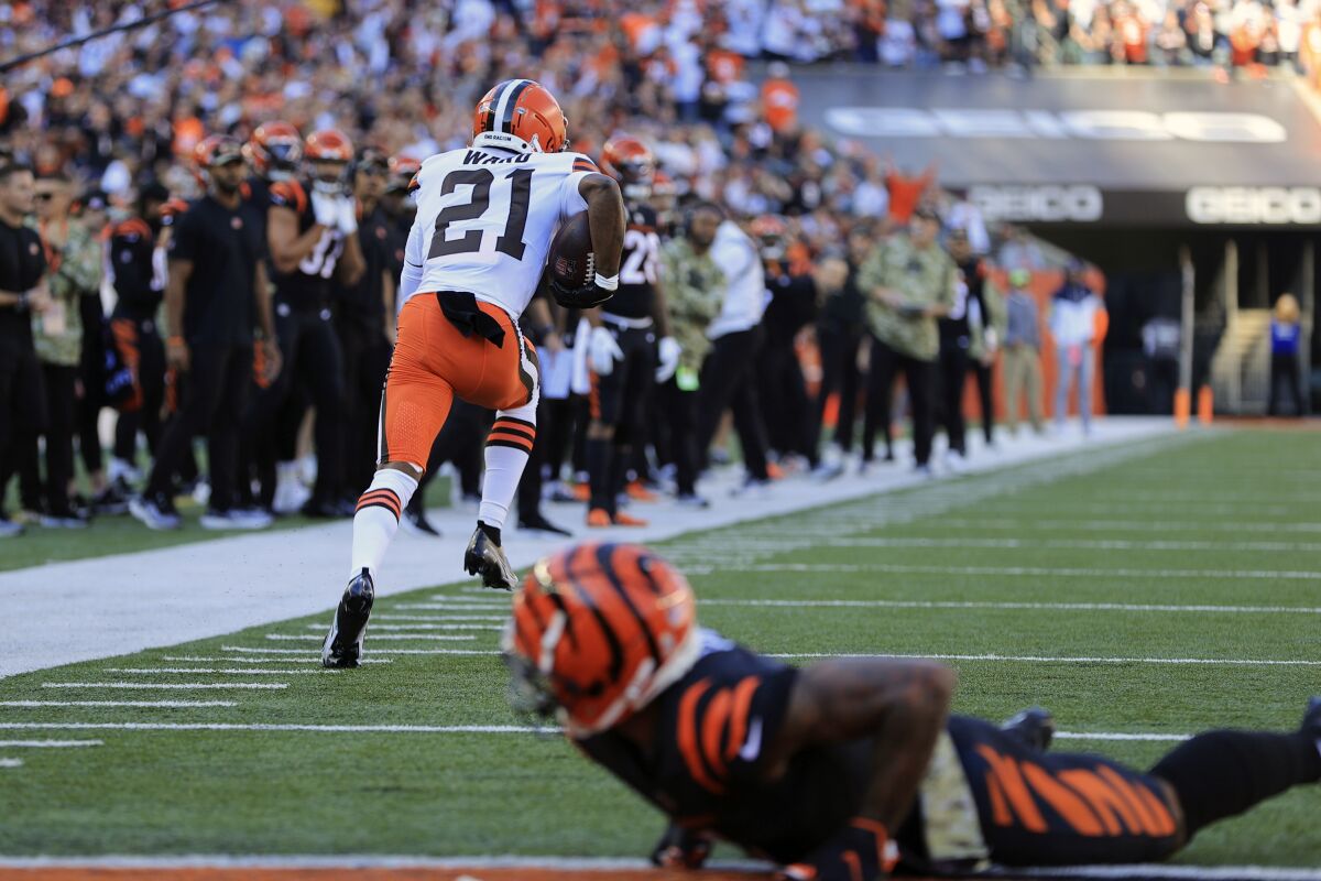 Cleveland Browns' Denzel Ward (21) returns an interception for a touchdown during the first half of an NFL football game against the Cincinnati Bengals, Sunday, Nov. 7, 2021, in Cincinnati. (AP Photo/Aaron Doster)