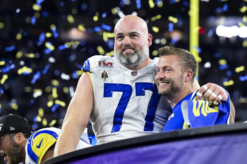 Rams coach Sean McVay embraces lineman Andrew Whitworth after the team won the Super Bowl.