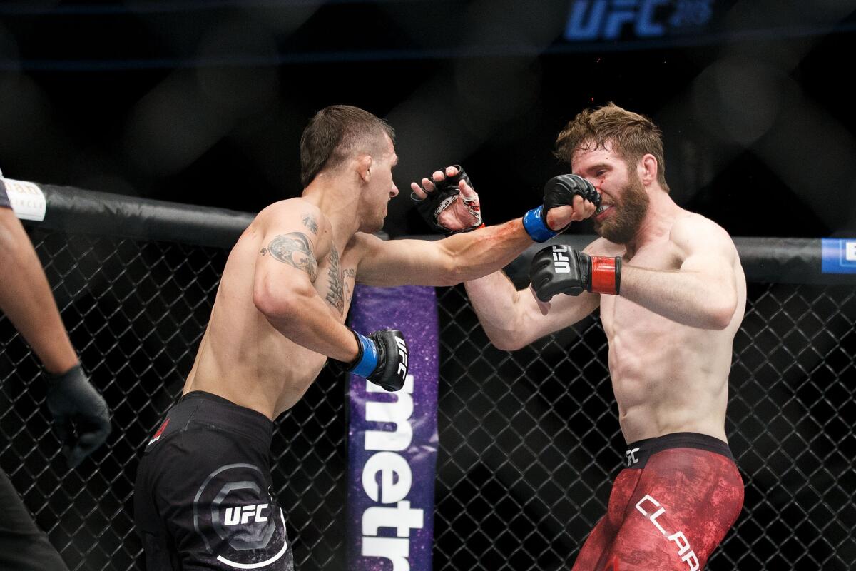 Mitch Clarke connects with a left against Alex White during their first at UFC 215.