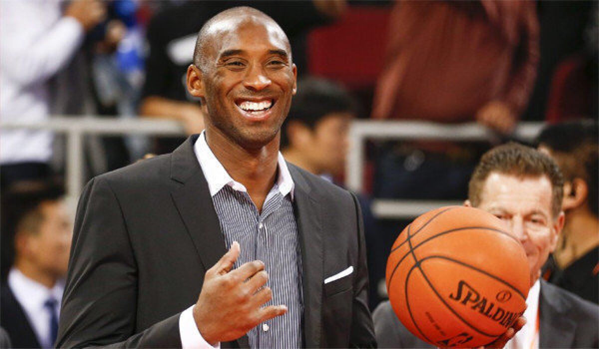 Kobe Bryant smiles before the Lakers face the Golden State Warriors in an exhibition game in Beijing.