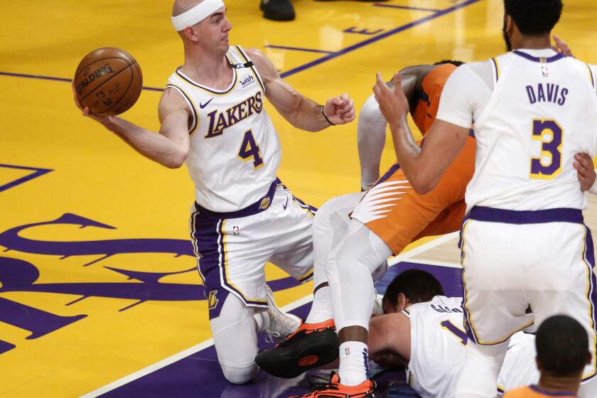 LOS ANGELES, CA - MAY 30: Los Angeles Lakers guard Alex Caruso (4) scrambles for a loose ball in a game against the Phoenix Suns in the second quarter at the Staples Center on Sunday, May 30, 2021 in Los Angeles, CA. Game four of the NBA Western Conference first-round playoff series. (Gary Coronado / Los Angeles Times)