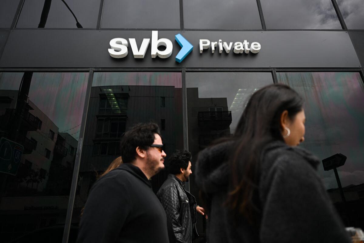 People stand outside a Silicon Valley Bank branch.