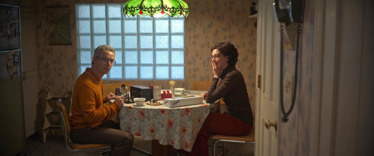 A man and woman sit at a kitchen table in a scene from "Armageddon Time."