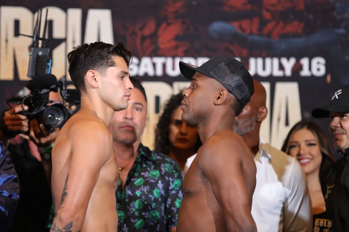 Ryan Garcia, left, and Javier Fortuna stare down one another at their weigh-in in Los Angeles on Friday.