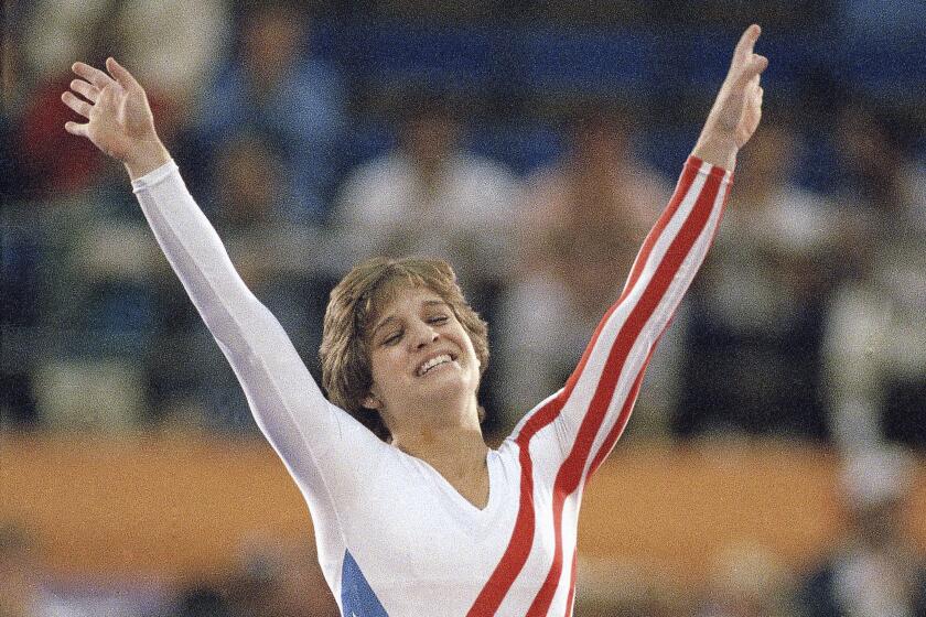 Mary Lou Retton celebrates her balance beam score at the 1984 Olympic Games, Aug. 3, 1984 in Los Angeles.