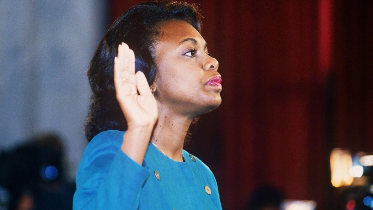 Anita Hill takes the oath on Oct. 12, 1991 before the Senate Judiciary Committee in Washington D.C. Hill filed sexual harassment charges against US Supreme Court nominee Clarence Thomas.