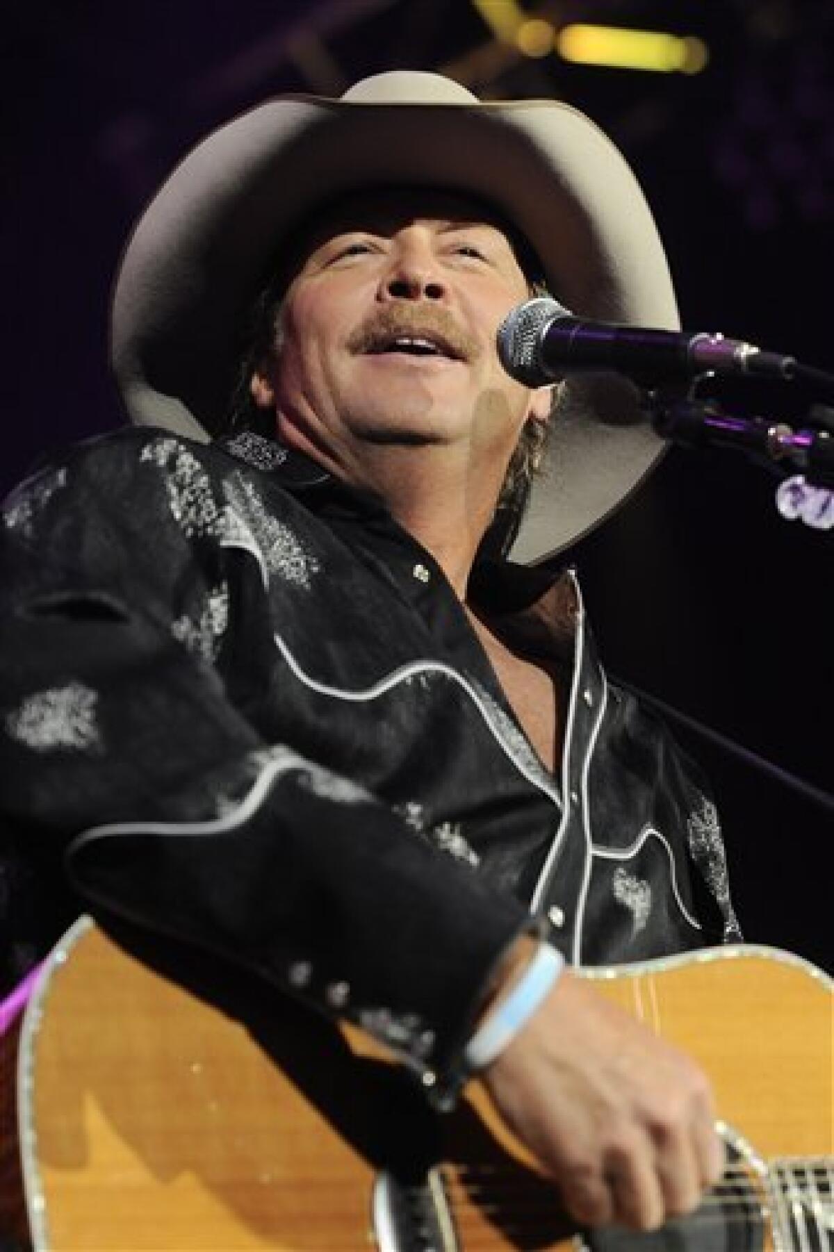 FILE - In this May 22, 2010 file photo, country singer Alan Jackson performs during a benefit show for the victims of the Upper Big Branch coal mine explosion at the Charleston Civic Center in Charleston, W.Va. (AP Photo/Jeff Gentner, file)