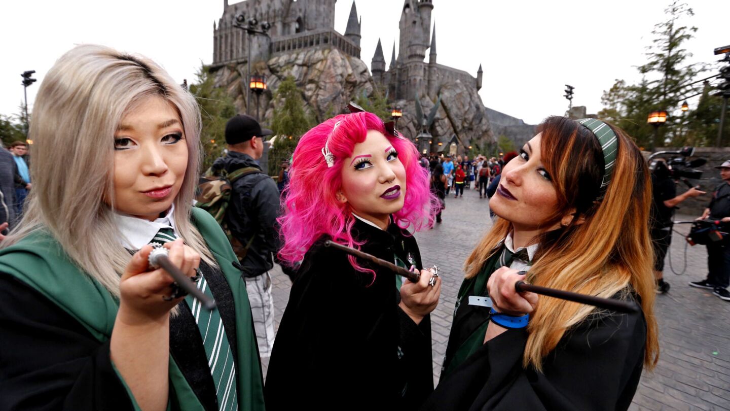 Diana Li, Bebe Lee and Katie Mitchell, from left, were among the first patrons to enter the Wizarding World of Harry Potter at Universal Studios Hollywood.