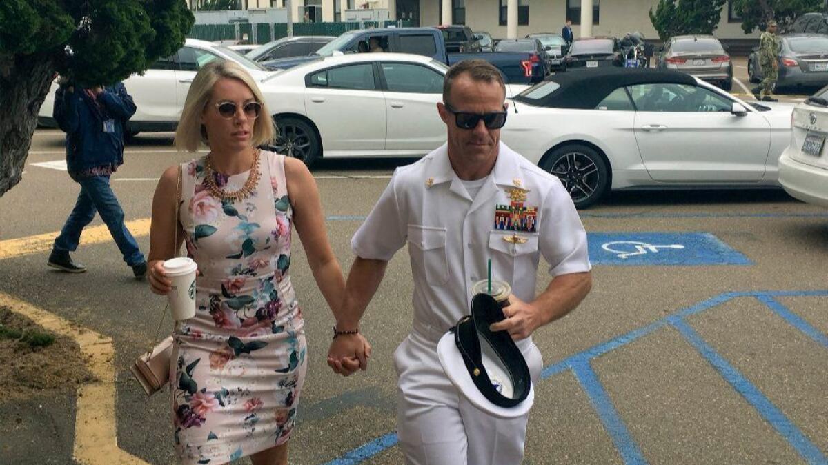 Navy Special Operations Chief Edward Gallagher walks with his wife, Andrea Gallagher, as they arrive to military court in San Diego on Thursday.