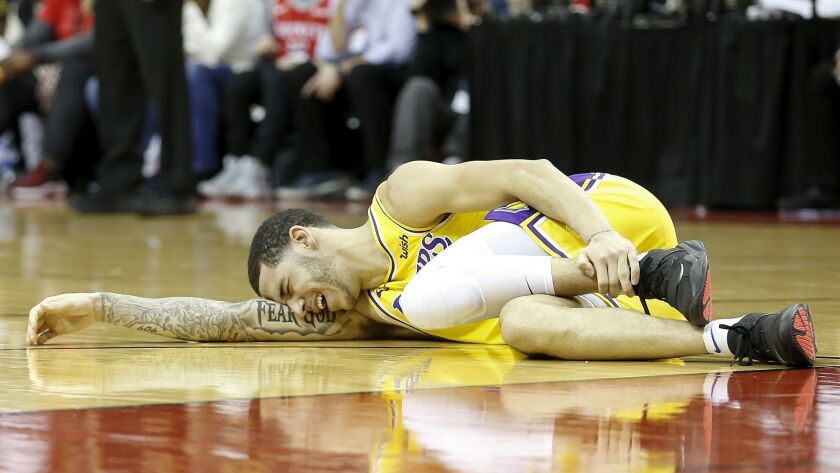 Lonzo Ball of the Lakers lays on the court after an injury in the second half against the Rockets at Toyota Center on Jan, 19 in Houston.