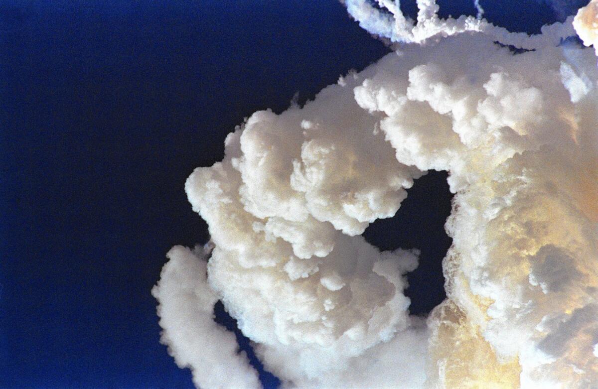 This file photo, taken on Jan. 28, 1986, shows a solid fuel rocket booster as it disappears behind the contrail of the explosion of the space shuttle Challenger over Kennedy Space Center as debris from the orbiter begins to fall to earth. The U.S. space shuttle exploded seconds after lift-off, killing its crew of seven.