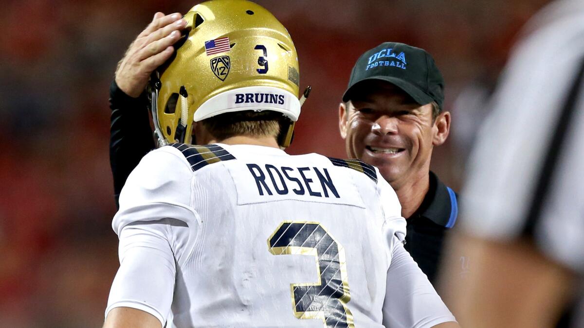 UCLA Coach Jim Mora congratulates quarterback Josh Rosen after he scrambled for a touchdown against Arizona in the third quarter Saturday at Arizona Stadium on Saturday.