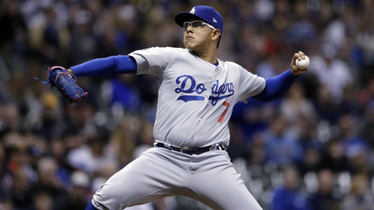 Julio Urias delivers during a game between the Dodgers and Milwaukee Brewers on April 18. Urias was placed on administrative leave after his arrest on suspicion of domestic battery.