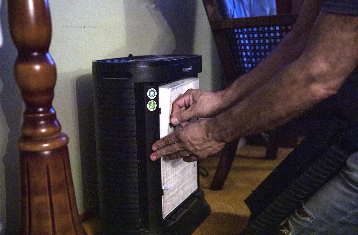 Manuel Andrade, 58, shows the filter of an air purifier on Wednesday, Oct. 4, 2023 in Imperial Beach, California. 