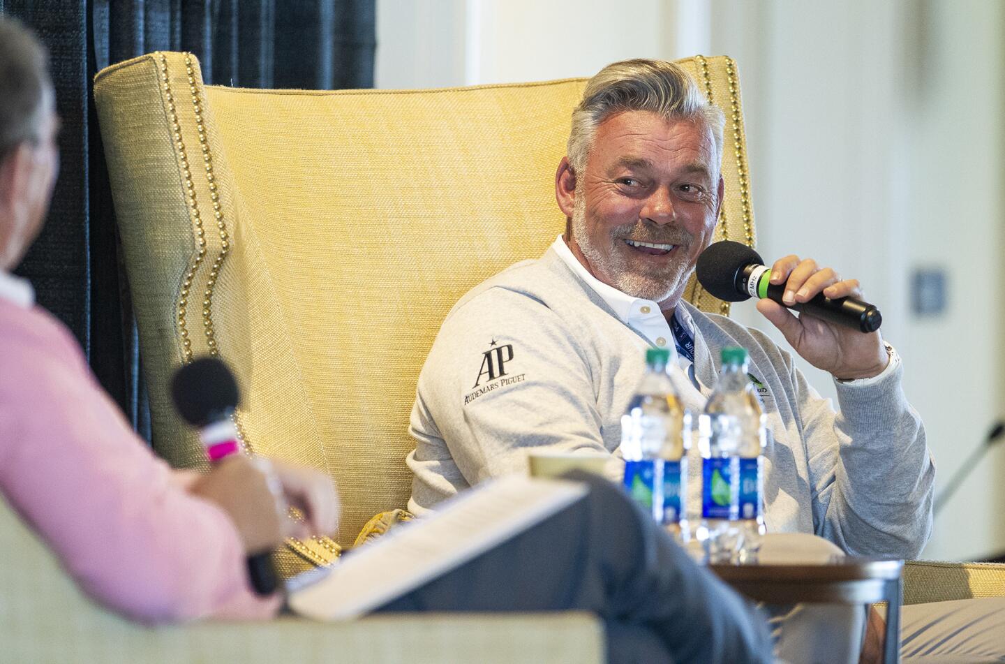 Golfer Darren Clarke, right, talks with Hank Adler, left, during the Hoag Classic's Breakfast with a Champion at Newport Beach Country Club on Tuesday.