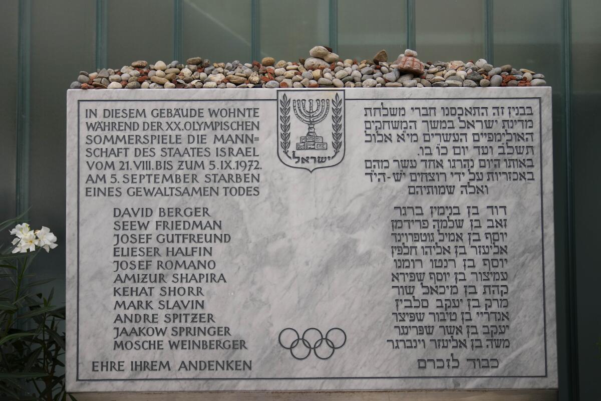 A memorial plaque for the eleven athletes from Israel and one German police officer were killed in a terrorist attack during the Olympic Games 1972, stands at the former accommodation of the Israeli team in the Olympic village in Munich, Germany, Saturday, Aug. 27, 2022. The families of 11 Israeli athletes killed by Palestinian attackers at the 1972 Summer Olympics and the German government are close to reaching a deal over the long-disputed amount of the compensation. (AP Photo/Matthias Schrader)