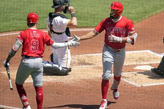 Los Angeles Angels' Jo Adell, right, is greeted by Zach Neto (9) after hitting a solo home run off Pittsburgh Pirates starting pitcher Martín Pérez during the third inning of a baseball game in Pittsburgh, Wednesday, May 8, 2024. (AP Photo/Gene J. Puskar)