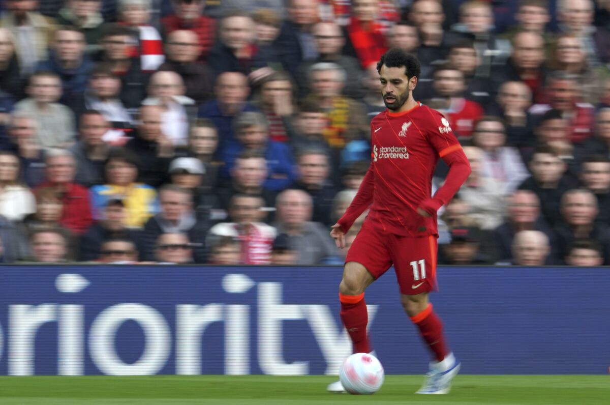 In this photo taken with slow shutter speed, Liverpool's Mohamed Salah runs during the English Premier League soccer match between Liverpool and Tottenham Hotspur at Anfield stadium in Liverpool, England, Saturday, May 7, 2022. (AP Photo/Jon Super)