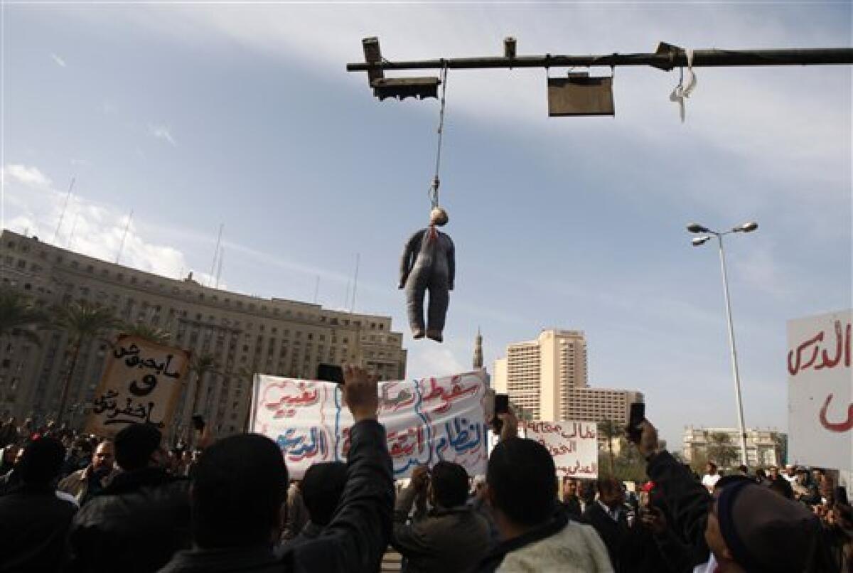 An effigy depicting President Hosni Mubarak hangs while perople demonstrate in Tahrir, or Liberation, Square in Cairo, Egypt, Tuesday, Feb. 1, 2011. Security officials say authorities have shut down all roads and public transportation to Cairo, where tens of thousands of people are converging to demand the ouster of Egyptian President Hosni Mubarak after nearly 30 years in power. (AP Photo/Khalil Hamra)