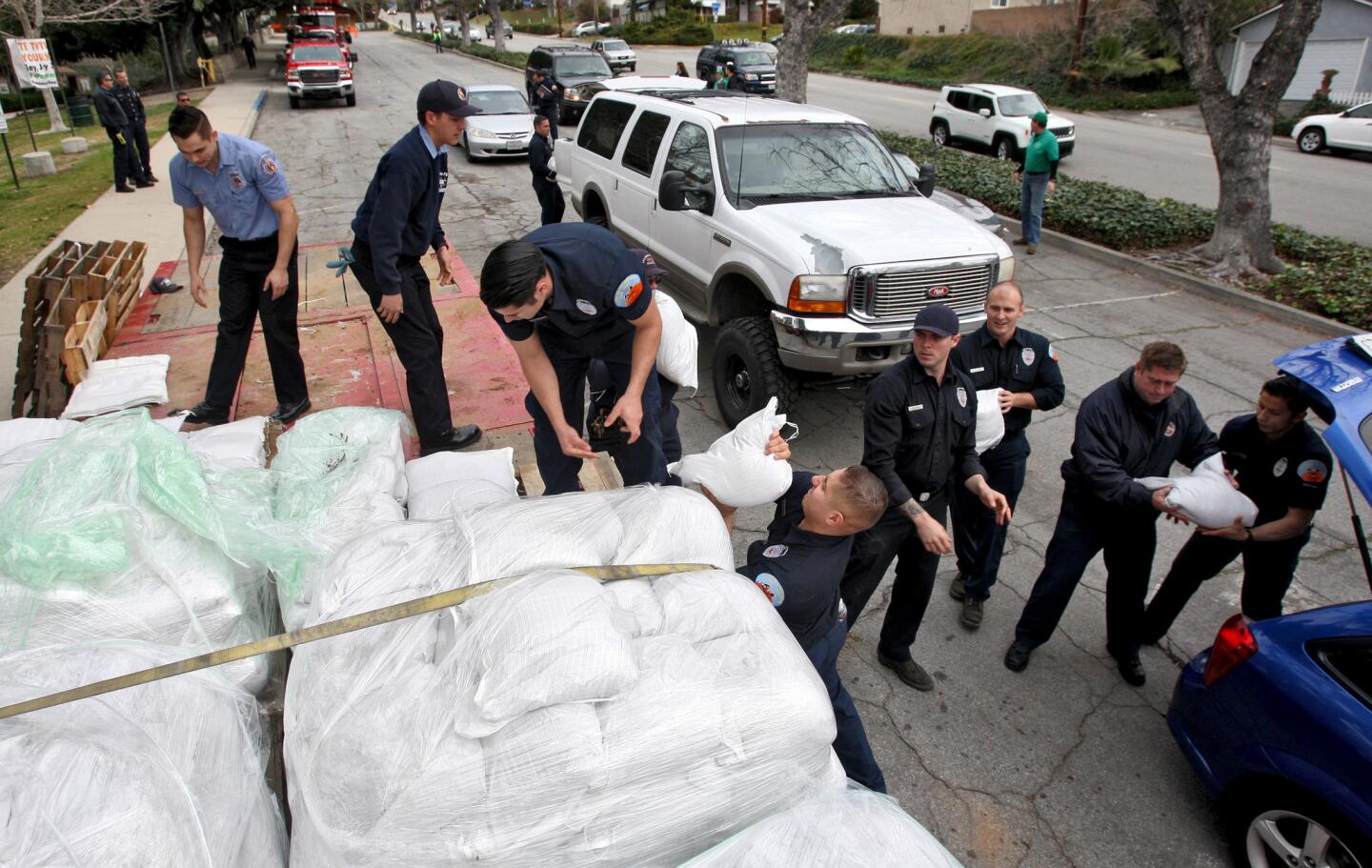 Los Angeles County Fire Dept. personnel from Camp Crew 2 and 9 and LA Co. La Cañada fire station 19 helped distribute 1,000 pre-filled sandbags to local residents at Two Strike Park in La Crescenta on Saturday, Jan. 23, 2016. The firefighters also filled an additional 2,000 sandbags with sand brought in from the Antelope Valley. Anyone needed additional sandbags can pick up more at their local fire department.