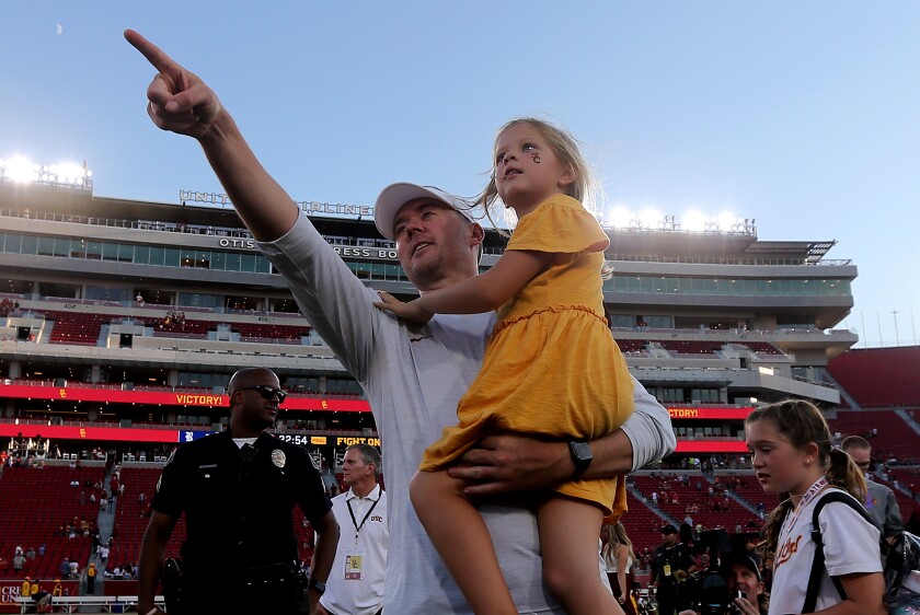 LOS ANGELES, CALIFORNIA. - Sep 3, 2022. USC head coach Lincoln Riley celebrates with his daughter.