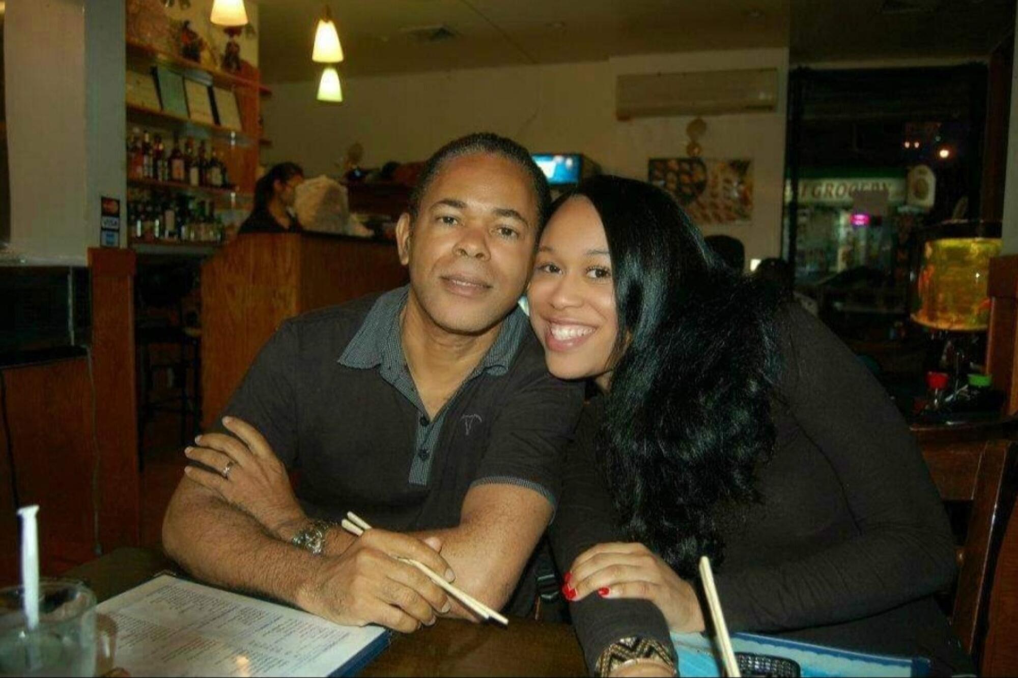 A man and woman sit together at a restaurant.